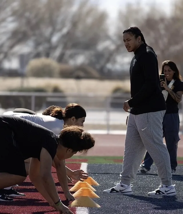 Trench House coach running a cone drill with linemen